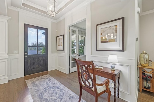 entryway with a chandelier, dark hardwood / wood-style flooring, and a wealth of natural light