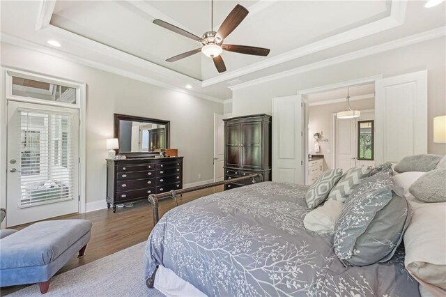 bedroom featuring ceiling fan, a raised ceiling, and multiple windows