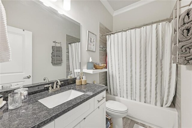 full bathroom with shower / tub combo with curtain, vanity, and toilet