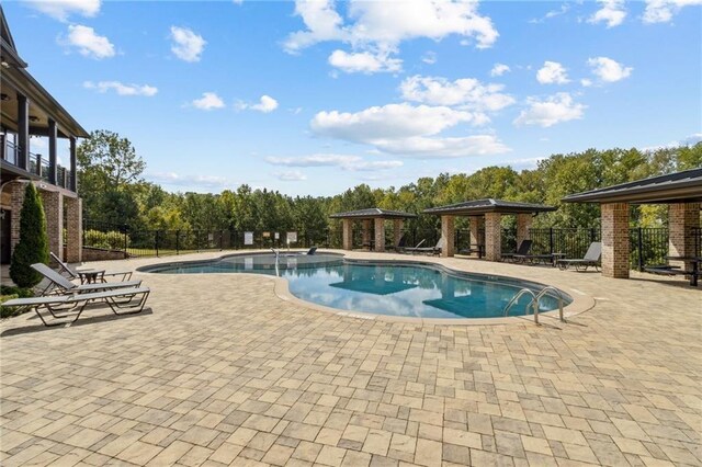 view of swimming pool with a patio area and a gazebo