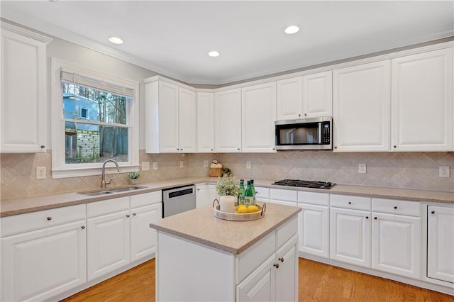 kitchen featuring white cabinetry, sink, tasteful backsplash, and stainless steel appliances