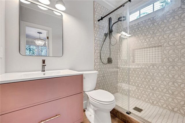 bathroom with vanity, an enclosed shower, and toilet