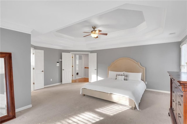 bedroom featuring a raised ceiling, crown molding, light carpet, and ceiling fan