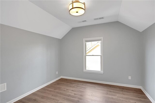 bonus room featuring vaulted ceiling and light hardwood / wood-style floors