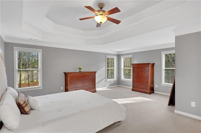 bedroom featuring crown molding, ceiling fan, a raised ceiling, and multiple windows