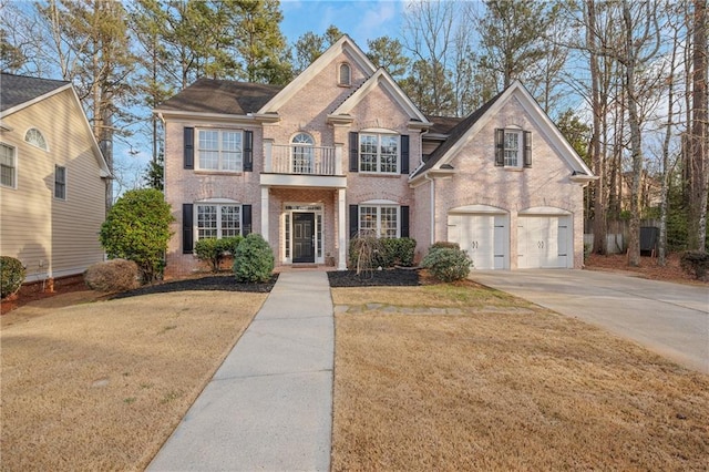 view of front of home with a balcony, a garage, and a front lawn