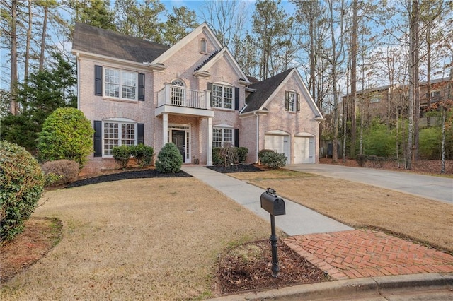 view of front facade with a garage, a balcony, and a front yard