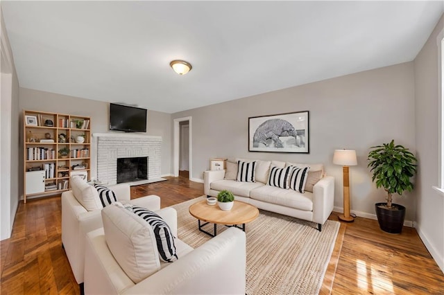 living room with a fireplace and hardwood / wood-style flooring