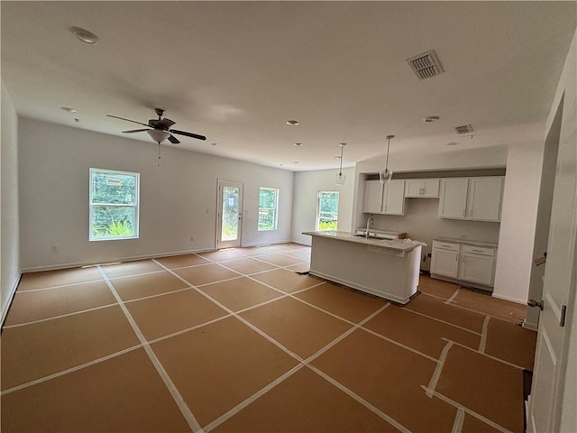 1119 Lockhart Way, Douglasville, GA 30135 - kitchen featuring open floor plan, a center island with sink, white cabinets, recessed lighting, and a ceiling fan
