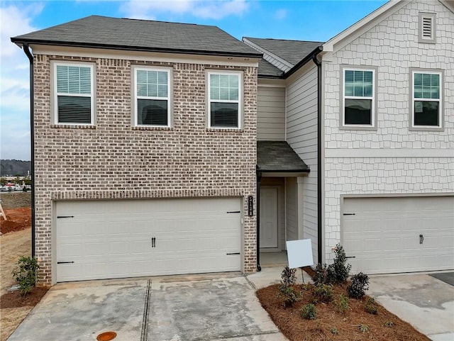 1119 Lockhart Way, Douglasville, GA 30135 - view of front of property featuring an attached garage, roof with shingles, concrete driveway, and brick siding