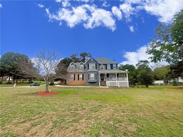 view of front of house with a porch and a front yard