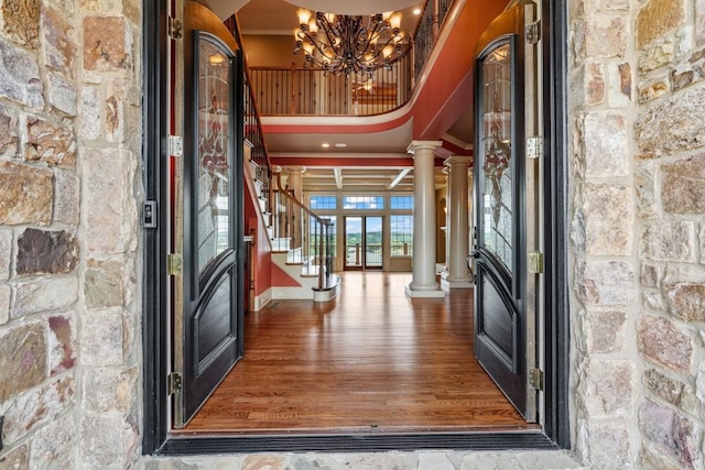 2742 High Vista Pt, Gainesville, GA 30501 - entrance foyer featuring decorative columns, a chandelier, stairway, ornamental molding, and wood finished floors