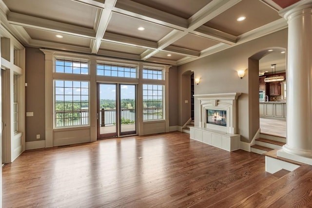 2742 High Vista Pt, Gainesville, GA 30501 - unfurnished living room featuring wood finished floors, arched walkways, healthy amount of natural light, coffered ceiling, and recessed lighting