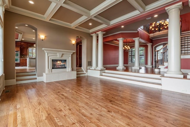 2742 High Vista Pt, Gainesville, GA 30501 - unfurnished living room with coffered ceiling, crown molding, a glass covered fireplace, stairs, and wood finished floors