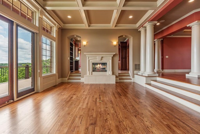 2742 High Vista Pt, Gainesville, GA 30501 - unfurnished living room featuring ornate columns, a glass covered fireplace, ornamental molding, wood finished floors, and coffered ceiling