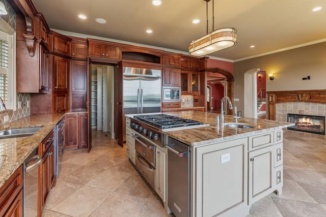 2742 High Vista Pt, Gainesville, GA 30501 - kitchen featuring a sink, built in appliances, ornamental molding, tasteful backsplash, and arched walkways