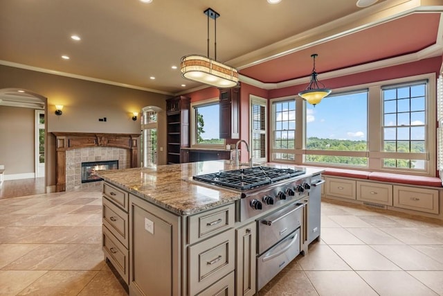 2742 High Vista Pt, Gainesville, GA 30501 - kitchen with a warming drawer, crown molding, a kitchen island, recessed lighting, and a tiled fireplace