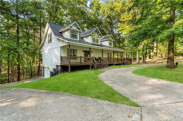 view of front of house with a front yard, a garage, and a porch