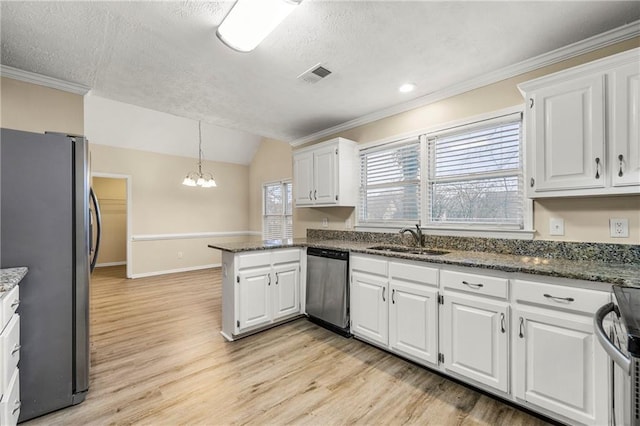 kitchen featuring sink, kitchen peninsula, decorative light fixtures, white cabinets, and appliances with stainless steel finishes