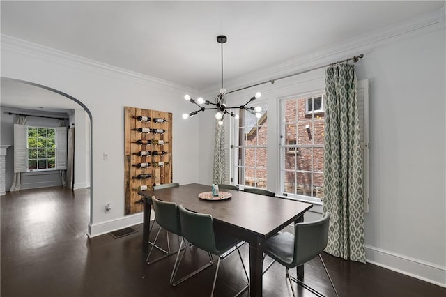 311 Glendale Ave, Decatur, GA 30030 - dining room with arched walkways, crown molding, a chandelier, and dark wood-style floors