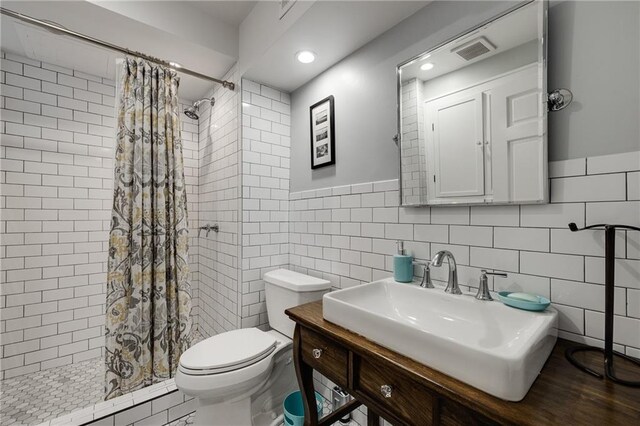 311 Glendale Ave, Decatur, GA 30030 - full bath featuring tile walls, a tile shower, vanity, recessed lighting, and a wainscoted wall