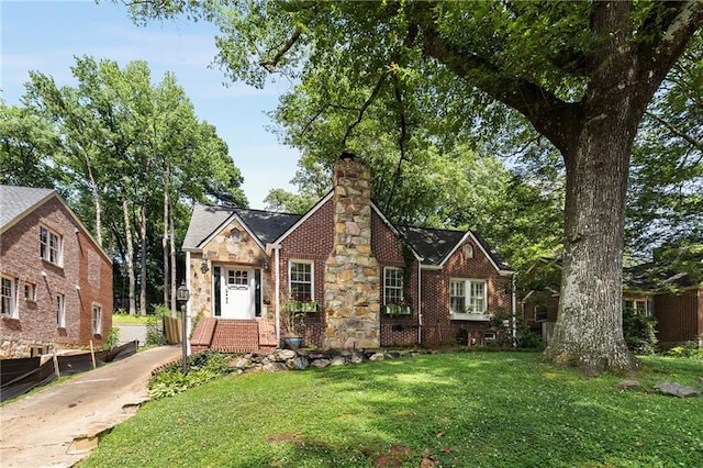 311 Glendale Ave, Decatur, GA 30030 - tudor home featuring a chimney, brick siding, and stone siding