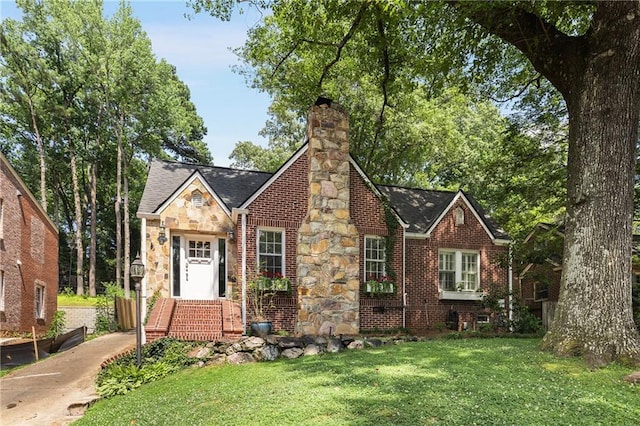 311 Glendale Ave, Decatur, GA 30030 - english style home featuring a front lawn, a chimney, stone siding, and roof with shingles