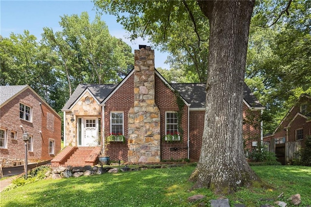 311 Glendale Ave, Decatur, GA 30030 - tudor-style house featuring a chimney, a front lawn, stone siding, brick siding, and roof with shingles
