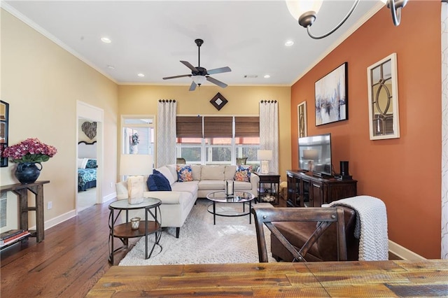 living room featuring wood finished floors, a ceiling fan, ornamental molding, and recessed lighting