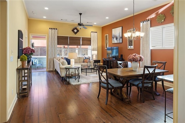 dining room with ornamental molding, ceiling fan with notable chandelier, and a healthy amount of sunlight