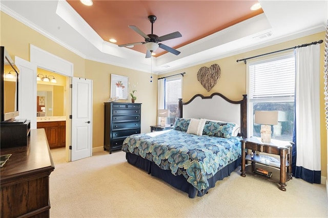 bedroom with crown molding, light carpet, and a raised ceiling