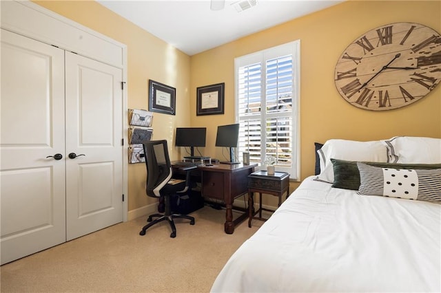 bedroom with a closet, carpet, visible vents, a ceiling fan, and baseboards