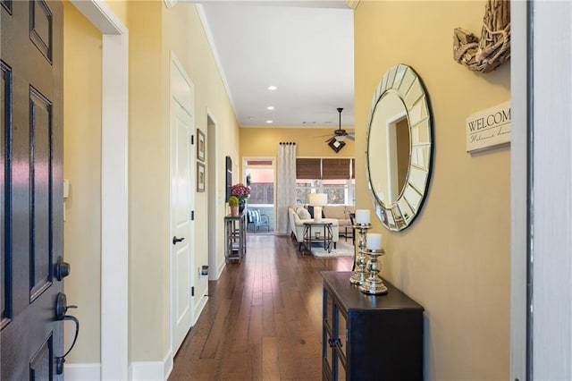 corridor with baseboards, dark wood-type flooring, and recessed lighting