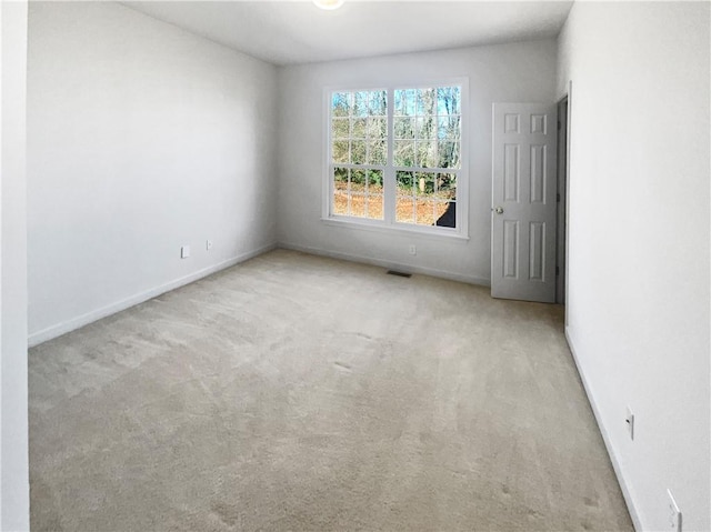 empty room featuring light carpet