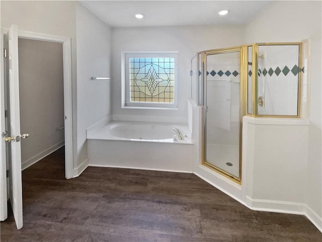 3905 Colonial Trl SW, Lilburn, GA 30047 - bathroom with a bath, a shower stall, wood finished floors, baseboards, and recessed lighting