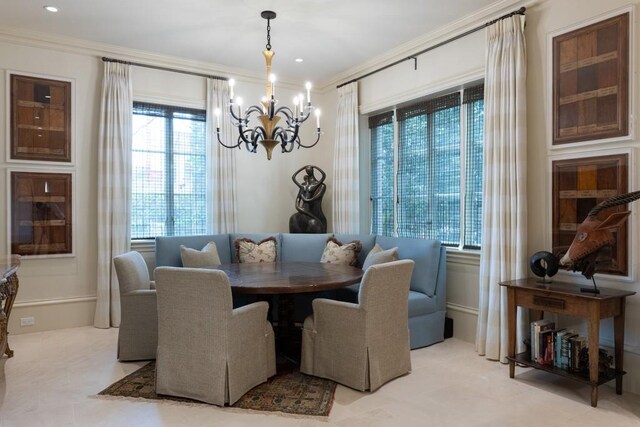 dining space with crown molding and a chandelier