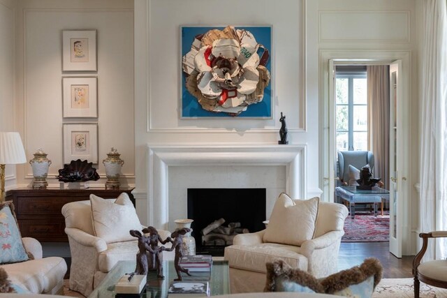 sitting room with wood finished floors and a fireplace