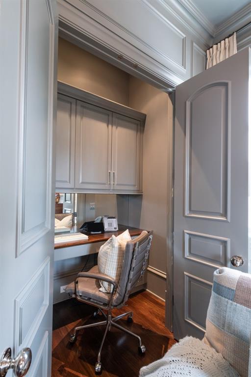 office space with crown molding and wood finished floors