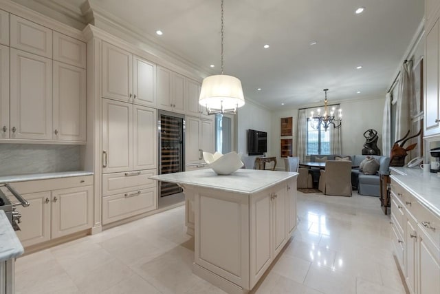 kitchen with a center island, decorative light fixtures, beverage cooler, open floor plan, and crown molding