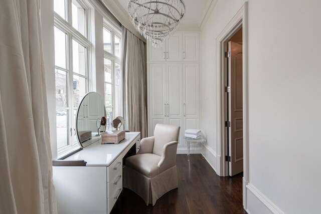 office area with baseboards, dark wood-style floors, ornamental molding, and a notable chandelier