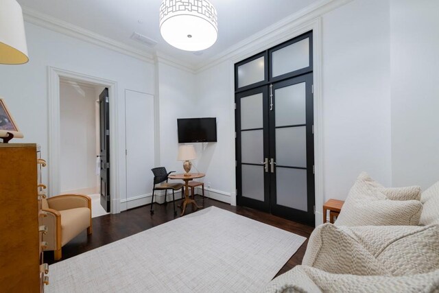 interior space with a baseboard radiator, ornamental molding, dark wood-style floors, and visible vents