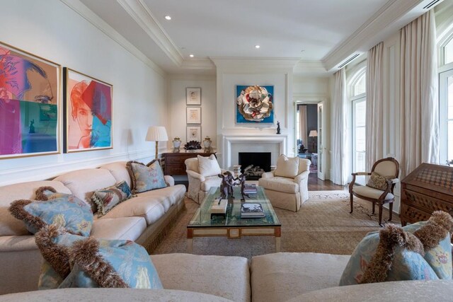 living room featuring a fireplace, crown molding, recessed lighting, and wood finished floors