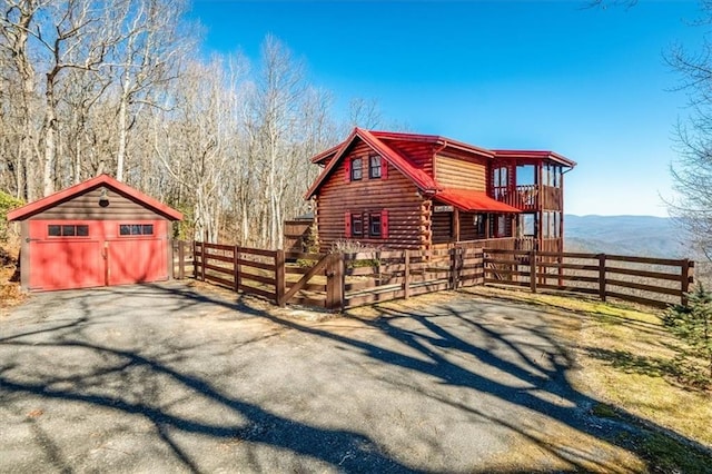 view of front of house with a garage, an outdoor structure, and a mountain view