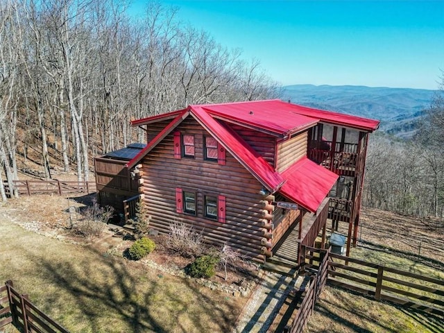 view of home's exterior featuring a mountain view and a lawn