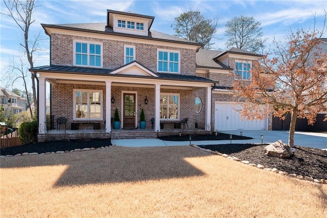 view of front facade with an attached garage, covered porch, concrete driveway, and brick siding