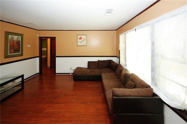 living room with dark wood-type flooring and ornamental molding