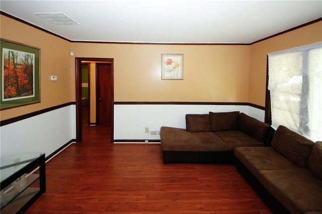 living room with crown molding and dark hardwood / wood-style flooring