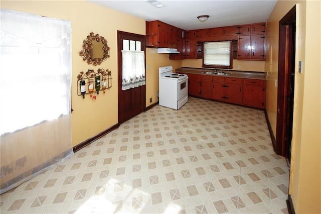 kitchen featuring white range with electric stovetop and sink