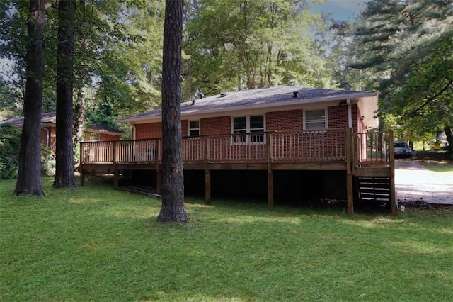 back of house with a deck and a lawn