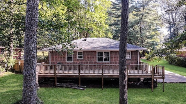 back of house with a wooden deck and a yard